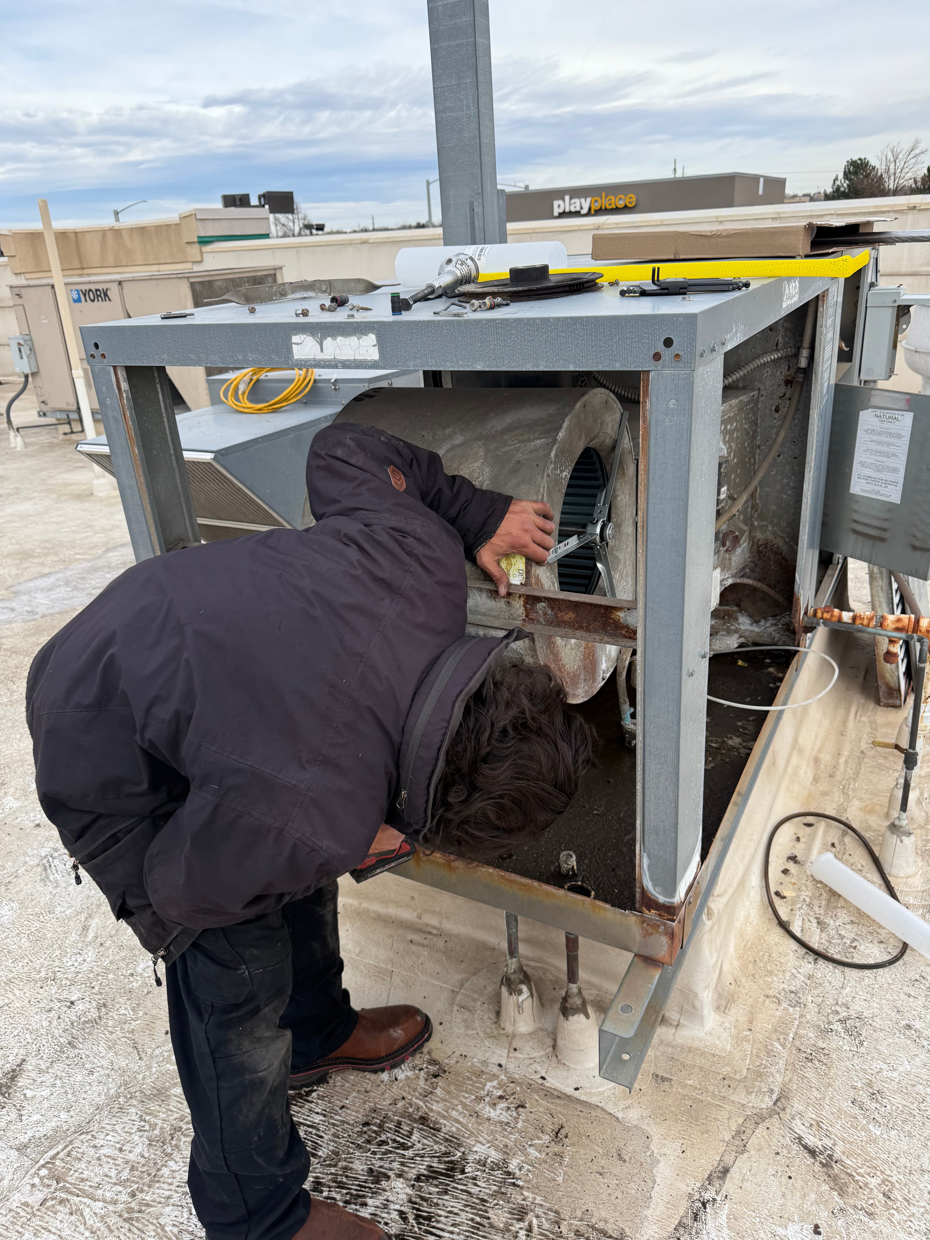Technician working on commercial HVAC equipment